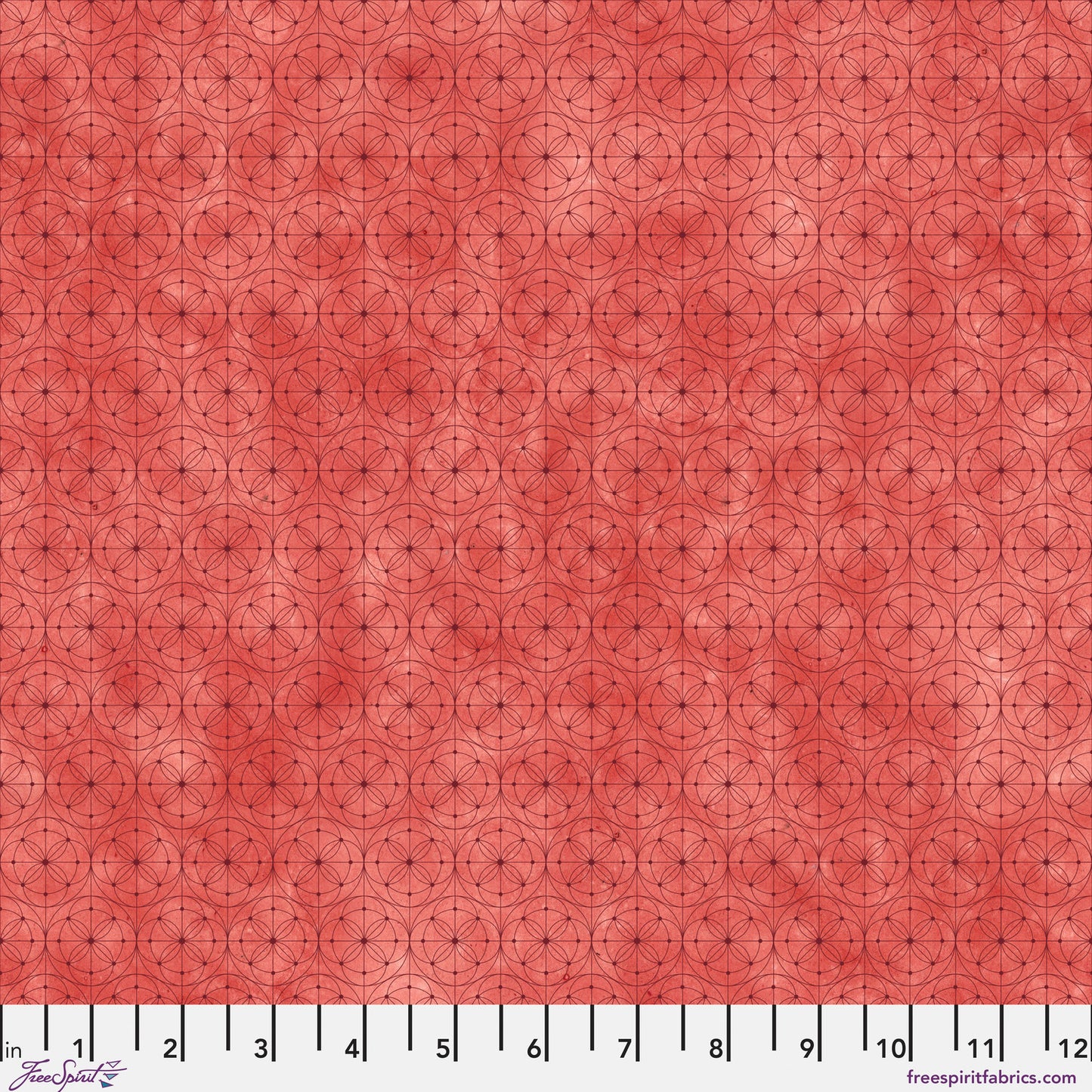 Fabric with a delicate allover geometric pattern of interlocking circles and starburst motifs on a tomato-red background. Ruler at the bottom for scale.