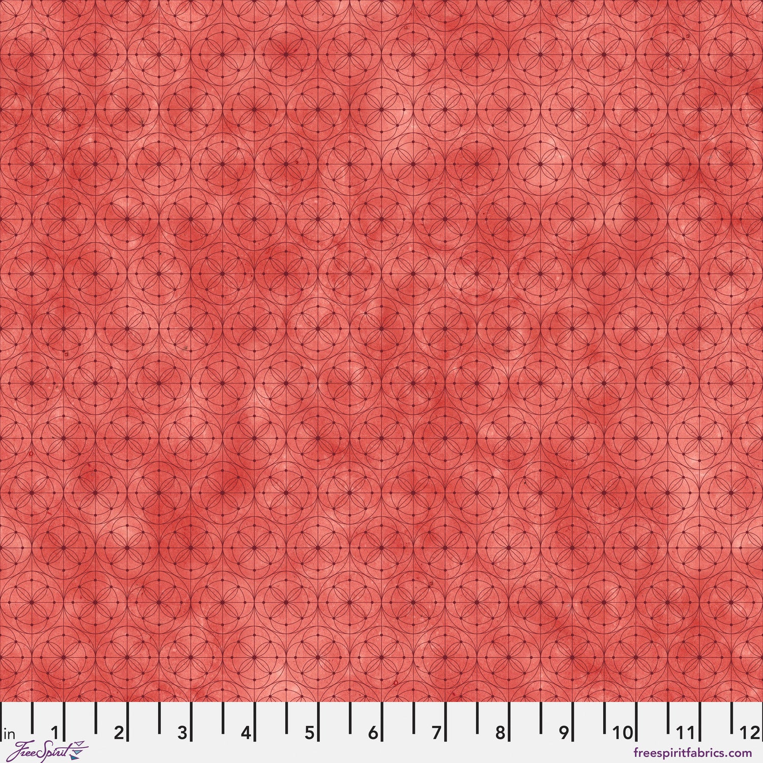 Fabric with a delicate allover geometric pattern of interlocking circles and starburst motifs on a tomato-red background. Ruler at the bottom for scale.