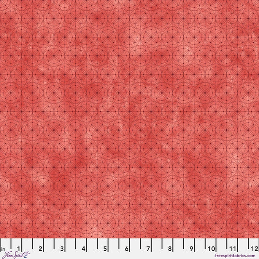 Fabric with a delicate allover geometric pattern of interlocking circles and starburst motifs on a tomato-red background. Ruler at the bottom for scale.