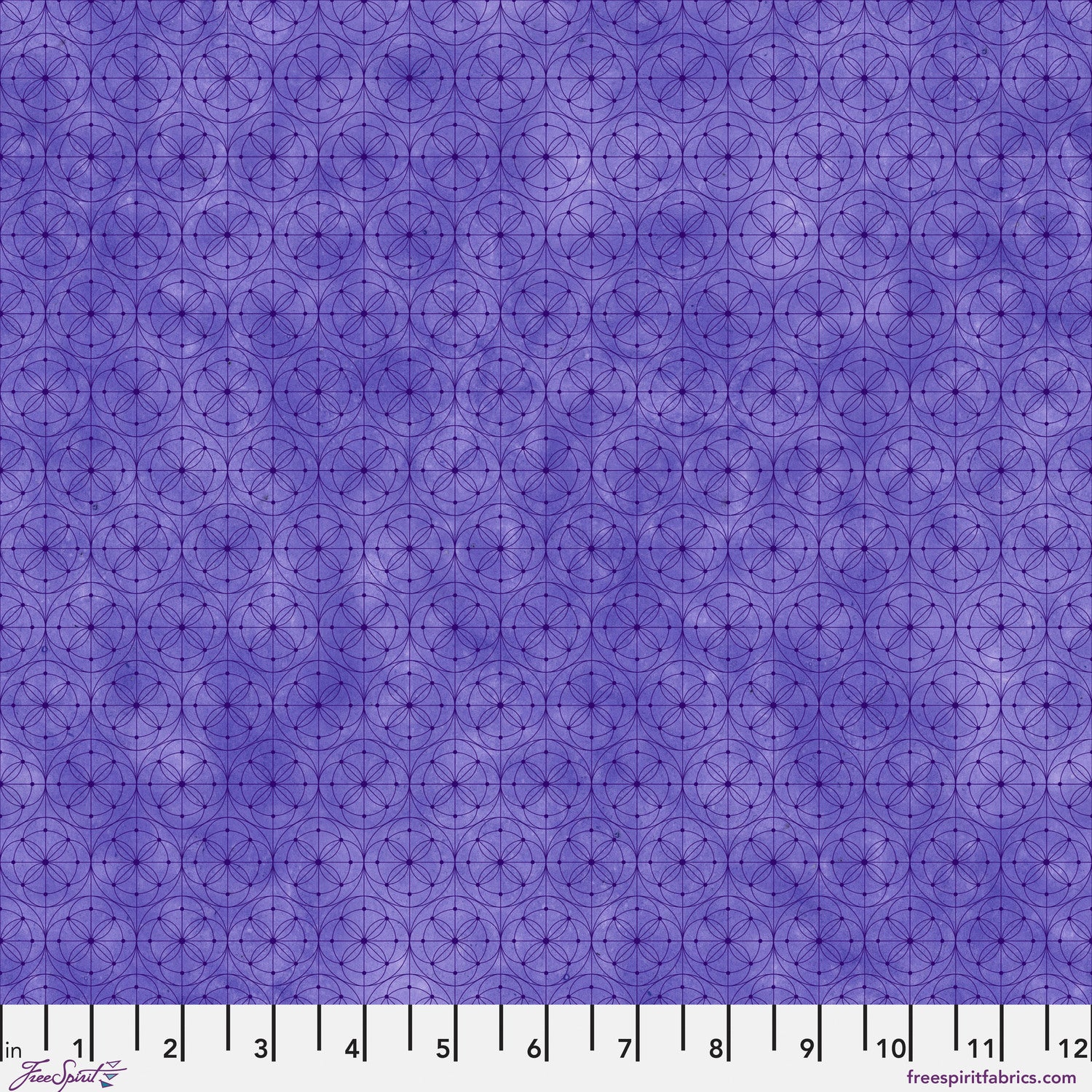 Purple fabric with a repeating geometric circle pattern, shown with a white ruler along the bottom edge for scale.