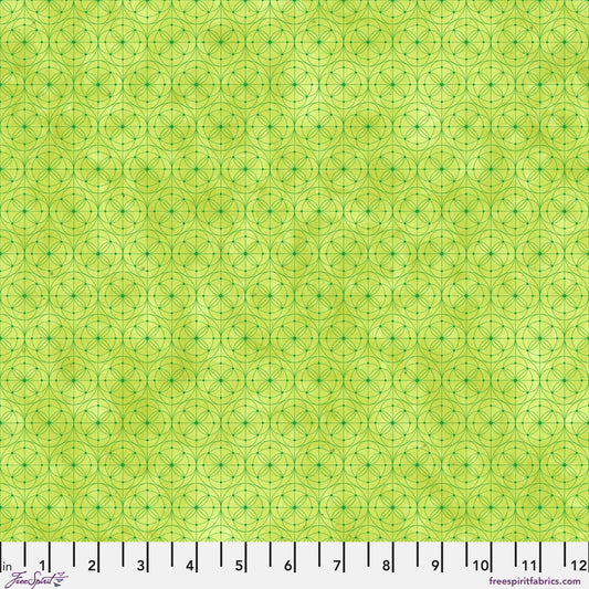 Fabric pattern featuring a repeating geometric design of interlocking circles and stars in lime green with a ruler along the bottom edge for scale.