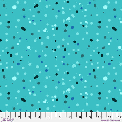 Fabric design with paint droplets in black, navy, and aqua tones splattered across a vivid turquoise background. Ruler at the bottom for scale.