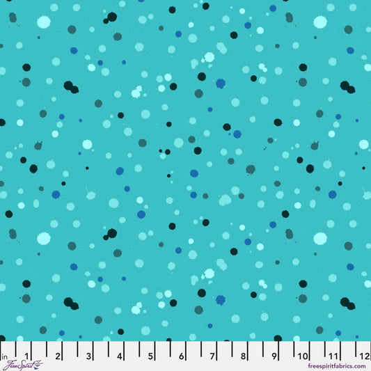 Fabric design with paint droplets in black, navy, and aqua tones splattered across a vivid turquoise background. Ruler at the bottom for scale.