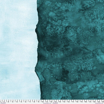 Abstract fabric pattern with a watercolor-like texture featuring dark teal and light, turquoise blue. Ruler at the bottom for scale.
