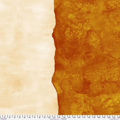 Abstract fabric pattern with a watercolor-like texture featuring burnt orange and light, peachy cream. Ruler at the bottom for scale.