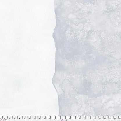 Abstract fabric pattern with a watercolor-like texture featuring silver-grey and clean, icy-white. Ruler at the bottom for scale.