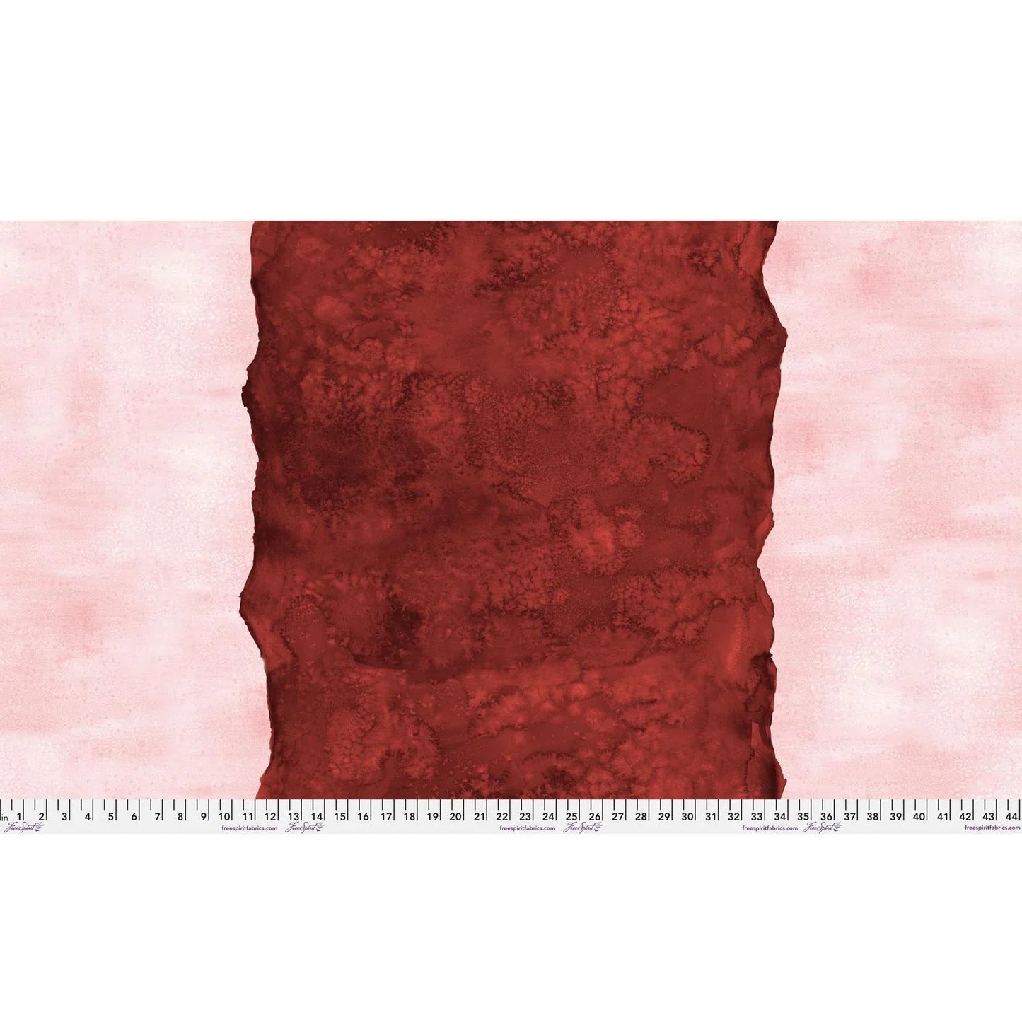 Abstract fabric pattern with a watercolor-like texture featuring a central stripe of dark red and outer light, blush pink edges. Ruler at the bottom for scale.