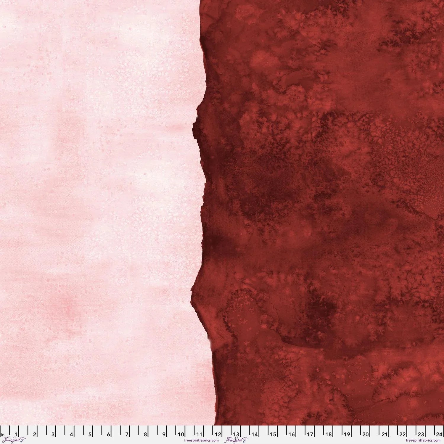 Abstract fabric pattern with a watercolor-like texture featuring dark red and light, blush-pink. Ruler at the bottom for scale.