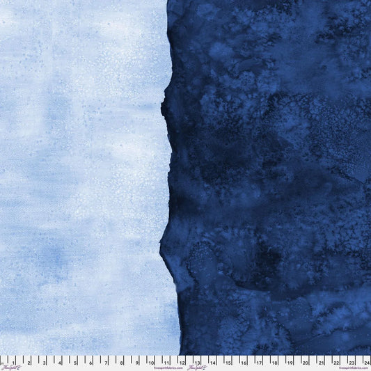 Abstract fabric pattern with a watercolor-like texture featuring dark navy and light, powder blue. Ruler at the bottom for scale.