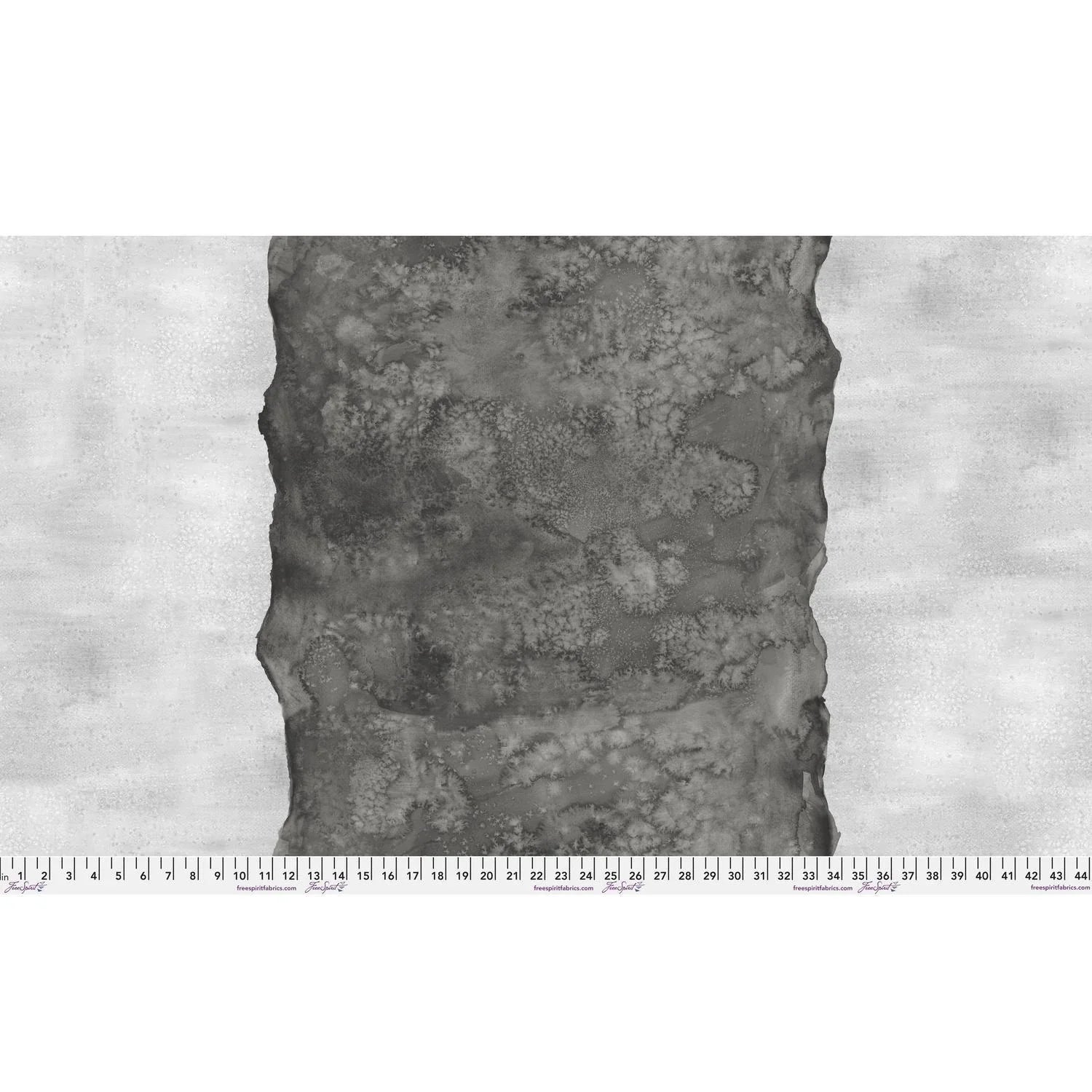 Abstract fabric pattern with a watercolor-like texture featuring a central stripe of dark charcoal and outer light, silver-grey edges. Ruler at the bottom for scale.