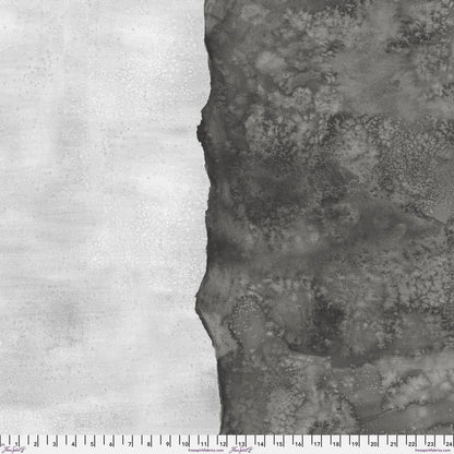 Abstract fabric pattern with a watercolor-like texture featuring dark charcoal and light, silver-grey. Ruler at the bottom for scale.