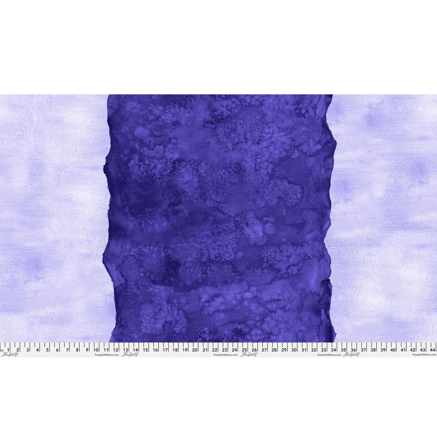 Abstract fabric pattern with a watercolor-like texture featuring a central stripe of dark indigo and outer light, lilac purple edges. Ruler at the bottom for scale.