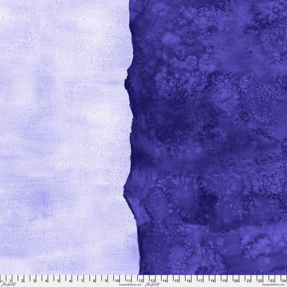 Abstract fabric pattern with a watercolor-like texture featuring dark indigo and light, lilac purple. Ruler at the bottom for scale.