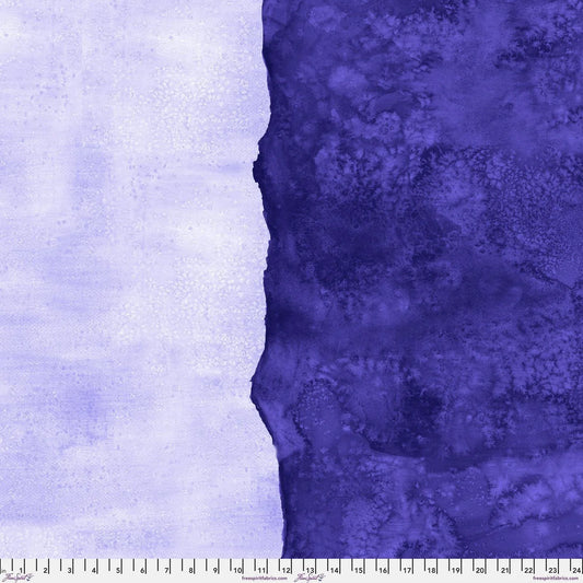 Abstract fabric pattern with a watercolor-like texture featuring dark indigo and light, lilac purple. Ruler at the bottom for scale.