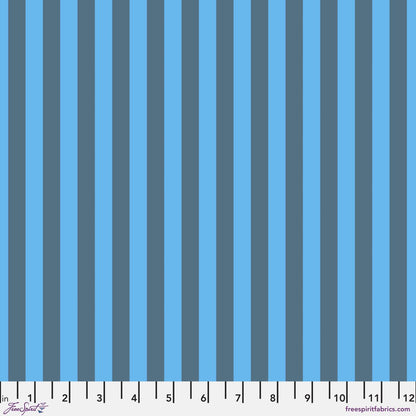 Neon Tent Stripe in Aura features alternating slate and cerulean blue stripes that run parallel to the selvage. 12 inch ruler at the bottom for scale