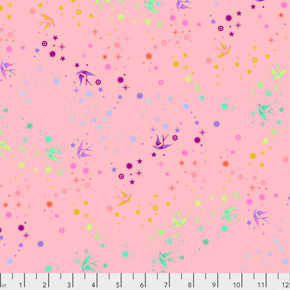 True Colors Fairy Dust in Blush features colorful birds swooping among fanciful rainbow stars on a rosy pink background.