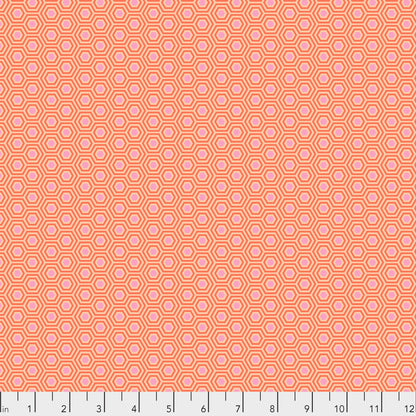 True Colors Hexy in Peach Blossom features soft pink dots that form the centers of small peach hexagons.