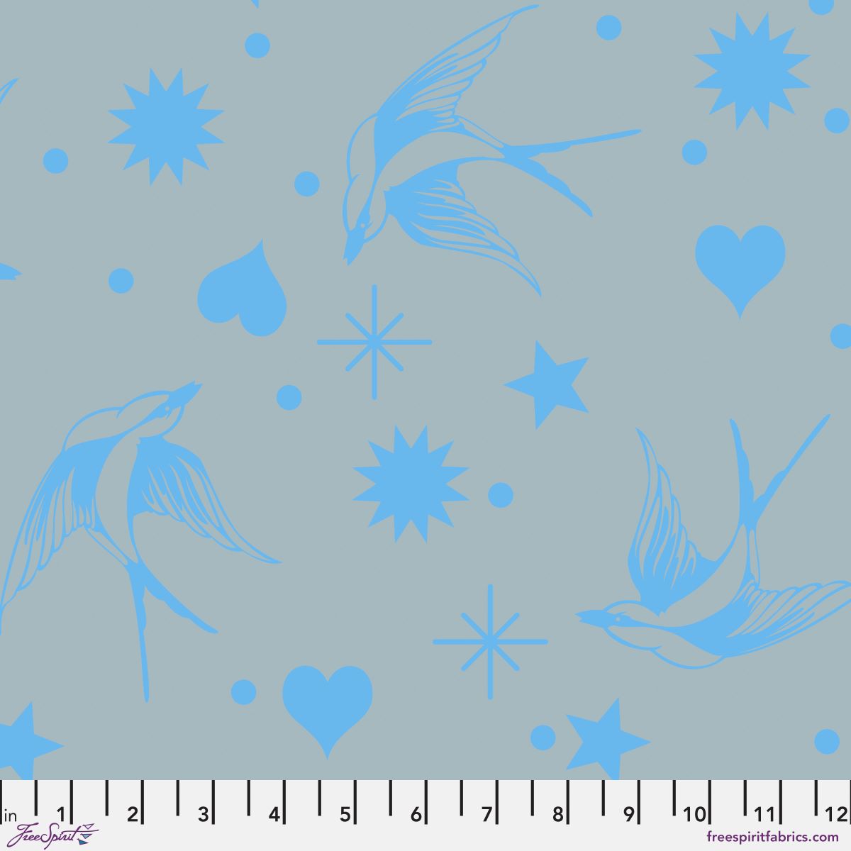 Neon Fairy Flakes in Aura features blue swooping birds, stars, hearts, and dots tossed across a blue-grey background. 12 inch ruler at the bottom for scale