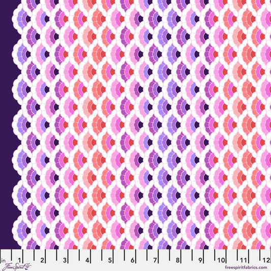 Geometric pattern of overlapping scalloped shapes with pink, coral, red, and purple colors on a dark background with a ruler for scale.