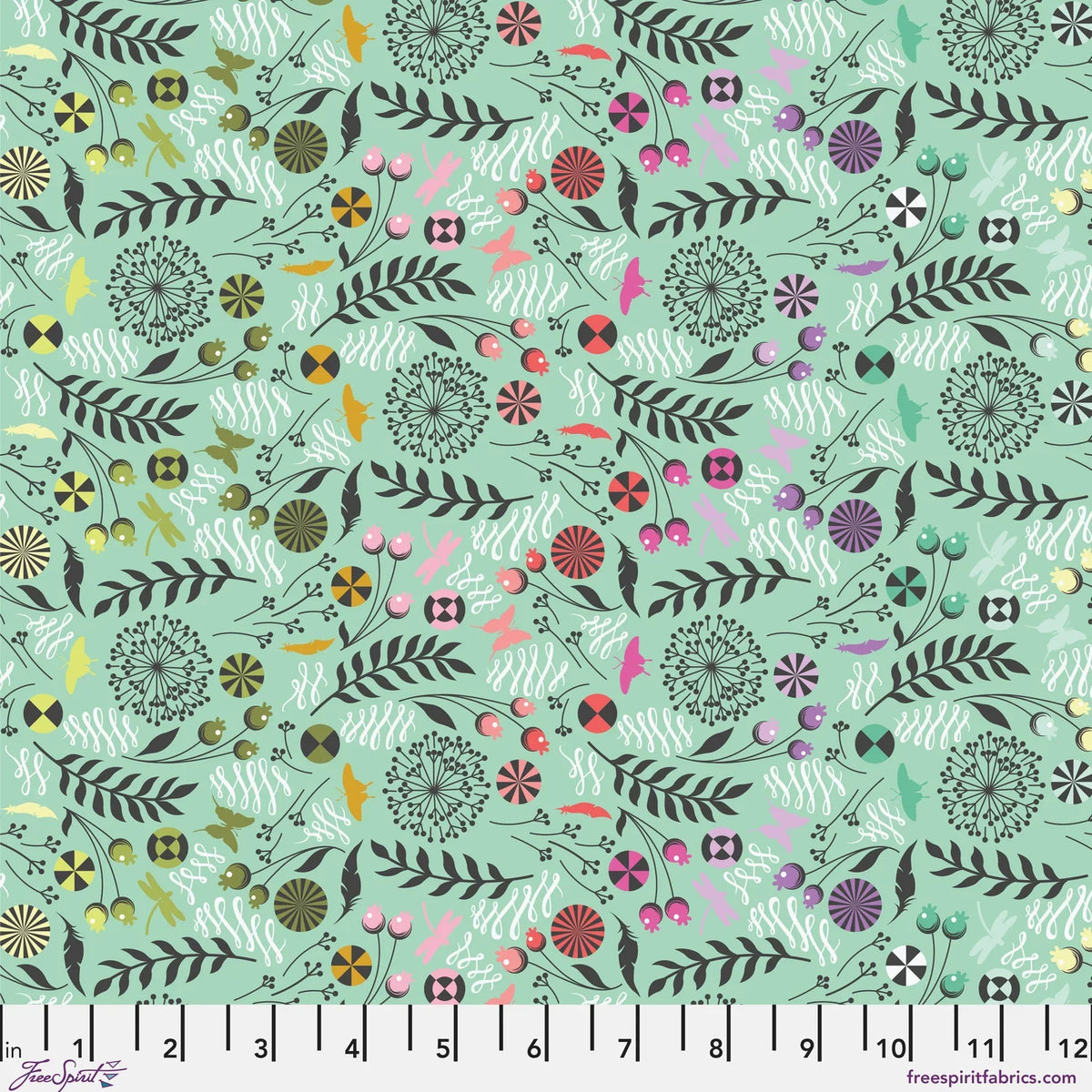 A seamless botanical fabric pattern featuring stylized leaves, flowers, butterflies, feathers, and flourishes in a variety of colors on a light mint green background. Ruler at the bottom for scale.