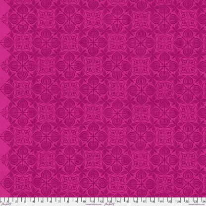 Grace Curious in Plum features large magenta tiles with intricate floral designs arranged on a bright, pink background. This tone-on-tone geometric design is set on a diagonal with the points meeting the selvage edges.