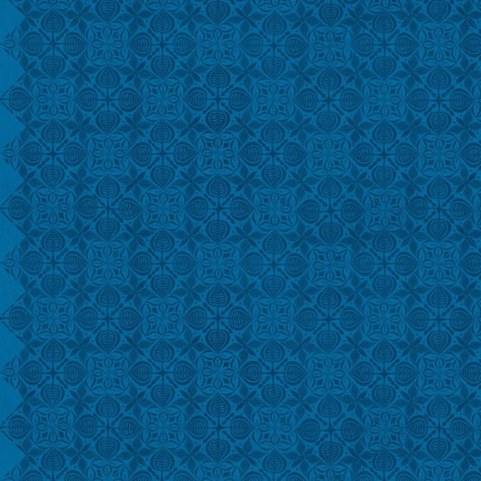 Grace Curious in Sapphire features large navy tiles with intricate floral designs arranged on a royal blue background. This tone-on-tone geometric design is set on a diagonal with the points meeting the selvage edges.