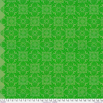 Grace Curious in Sorrel features large, bright green tiles with intricate floral designs arranged on a lime background. This tone-on-tone geometric design is set on a diagonal with the points meeting the selvage edges.