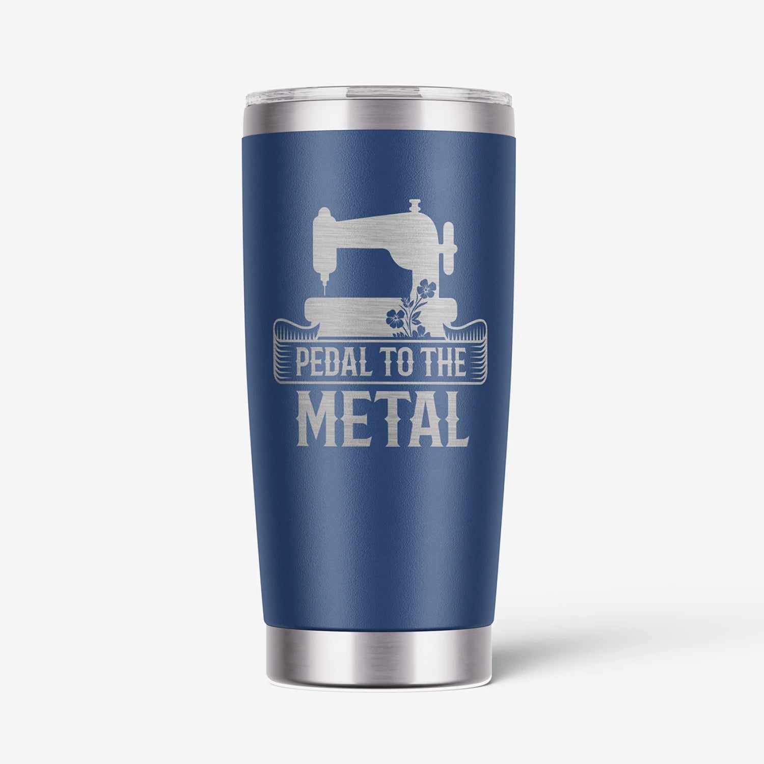 A navy blue insulated travel tumbler with a stainless steel lid and base, featuring a white graphic of a sewing machine and the text 'PEDAL TO THE METAL'.