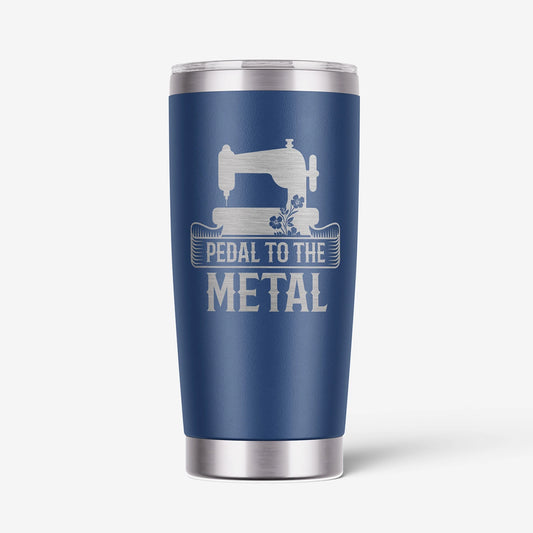 A navy blue insulated travel tumbler with a stainless steel lid and base, featuring a white graphic of a sewing machine and the text 'PEDAL TO THE METAL'.