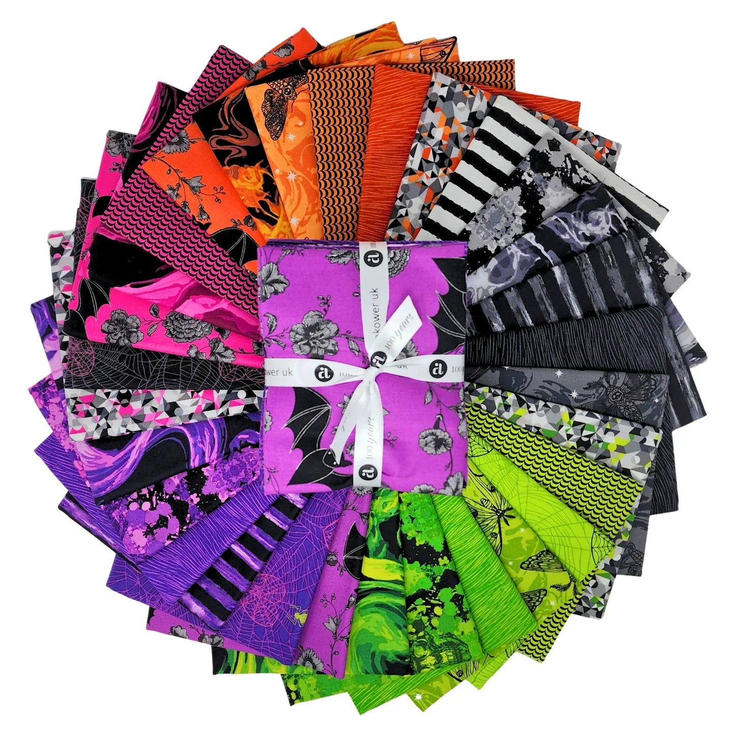 A fanned-out bundle of colorful fabric squares in vivid purples, oranges, greens, grays, and blacks, featuring floral designs, moths, spiderwebs, stripes, and abstract shapes with a Fat Quarter Bundle in the center.
