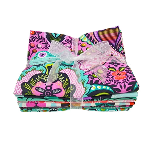 Stack of pink, teal, black, and white fabric squares tied with a white ribbon.