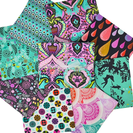 Circular arrangement of pink, teal, black, and white fabric swatches with geometric, floral, and animal designs a with a bundle tied with a white ribbon in the center.