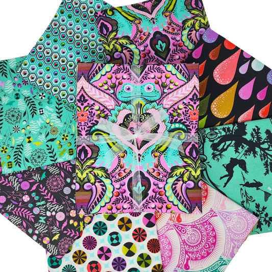 Circular arrangement of pink, teal, black, and white fabric swatches with geometric, floral, and animal designs a with a bundle tied with a white ribbon in the center.