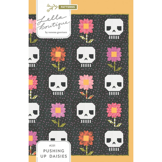 Pushing Up Daisies Quilt Pattern features alternating blocks of patchwork flowers and skulls.