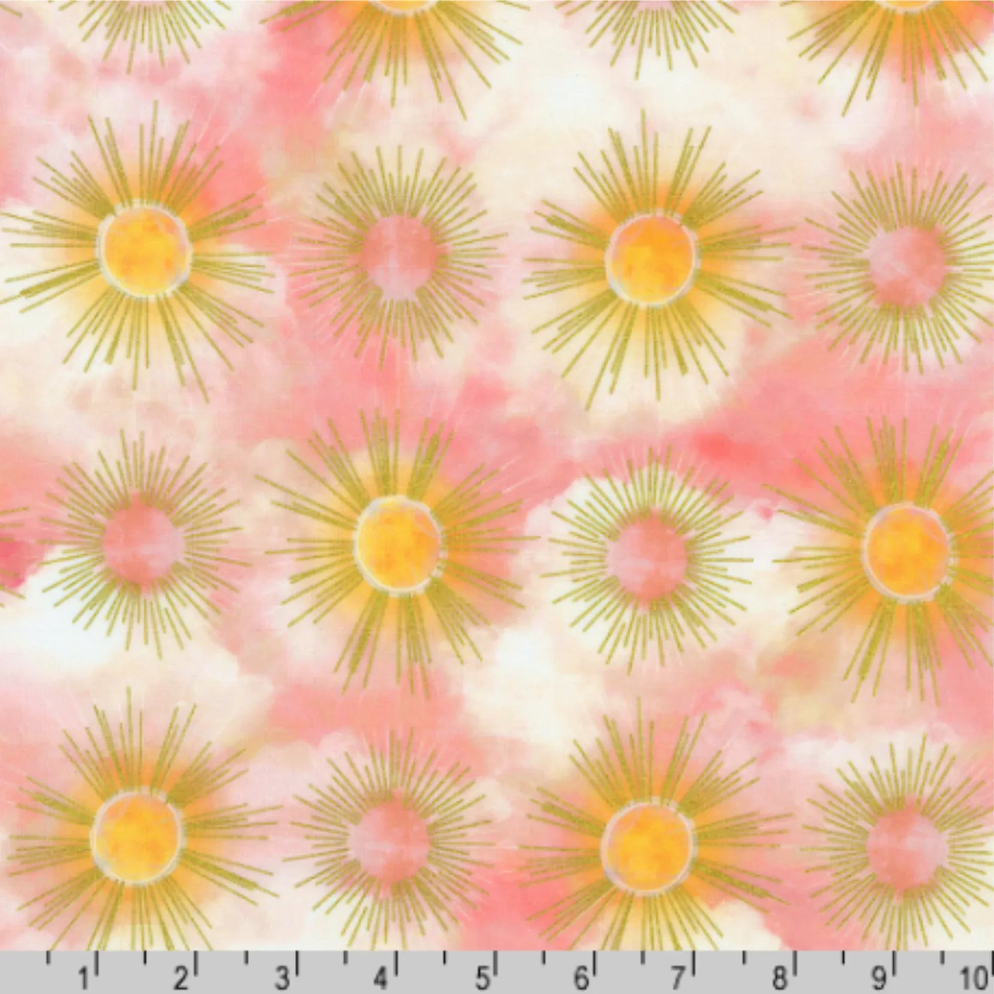 Pattern of sunburst designs with golden rays on a cloudy pink and off-white background with a ruler for scale