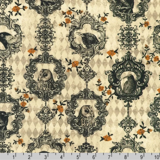 Fabric featuring black ravens and owls in ornate black scrollwork frames with small orange floral accents on a beige and taupe harlequin diamond background. Ruler at the bottom for scale.