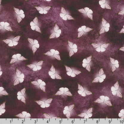 Patterned fabric of softly glowing white moth silhouettes scattered across a dark, mottled amethyst-purple background with a ruler at the bottom for scale.