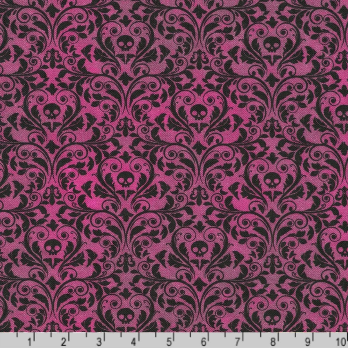 An ornate black damask pattern with small skull motifs on a rich, plum background with a ruler at the bottom for scale. 