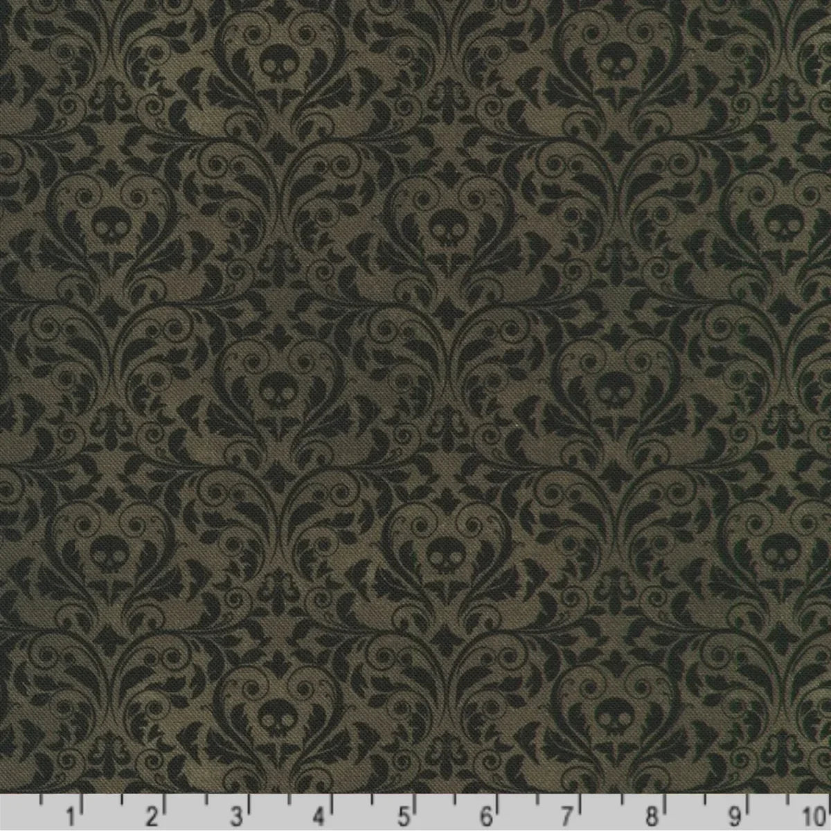An ornate black damask pattern with small skull motifs on a charcoal-black background with a ruler at the bottom for scale.