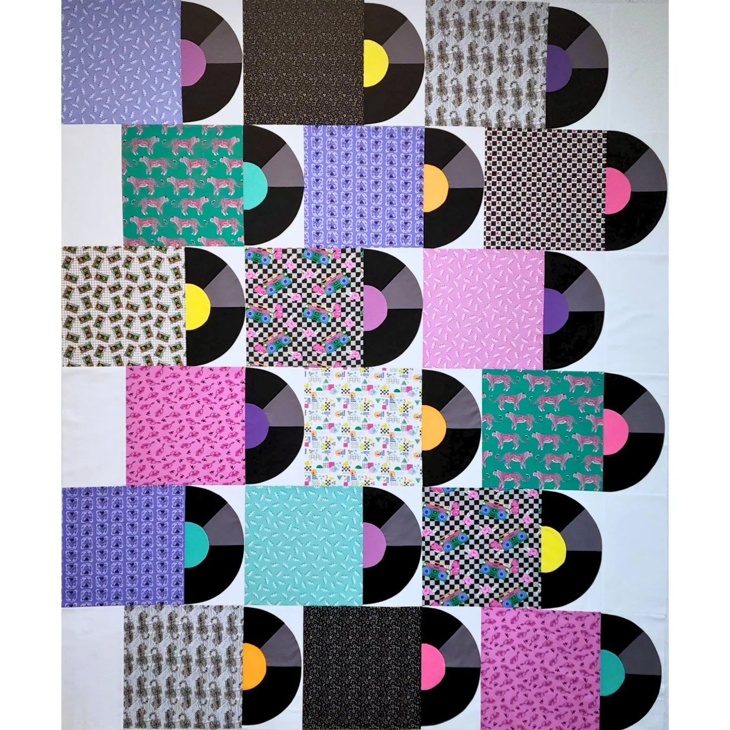 Patchwork quilt with vinyl record design on a white background