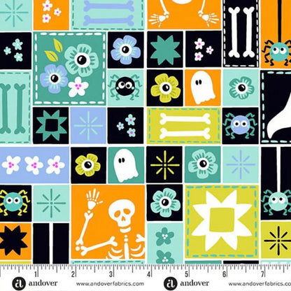 Colorful sampler-style print with Halloween-themed blocks and a ruler for scale.