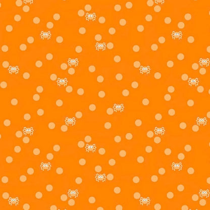 Orange fabric with peach polka dots and small cartoon spiders