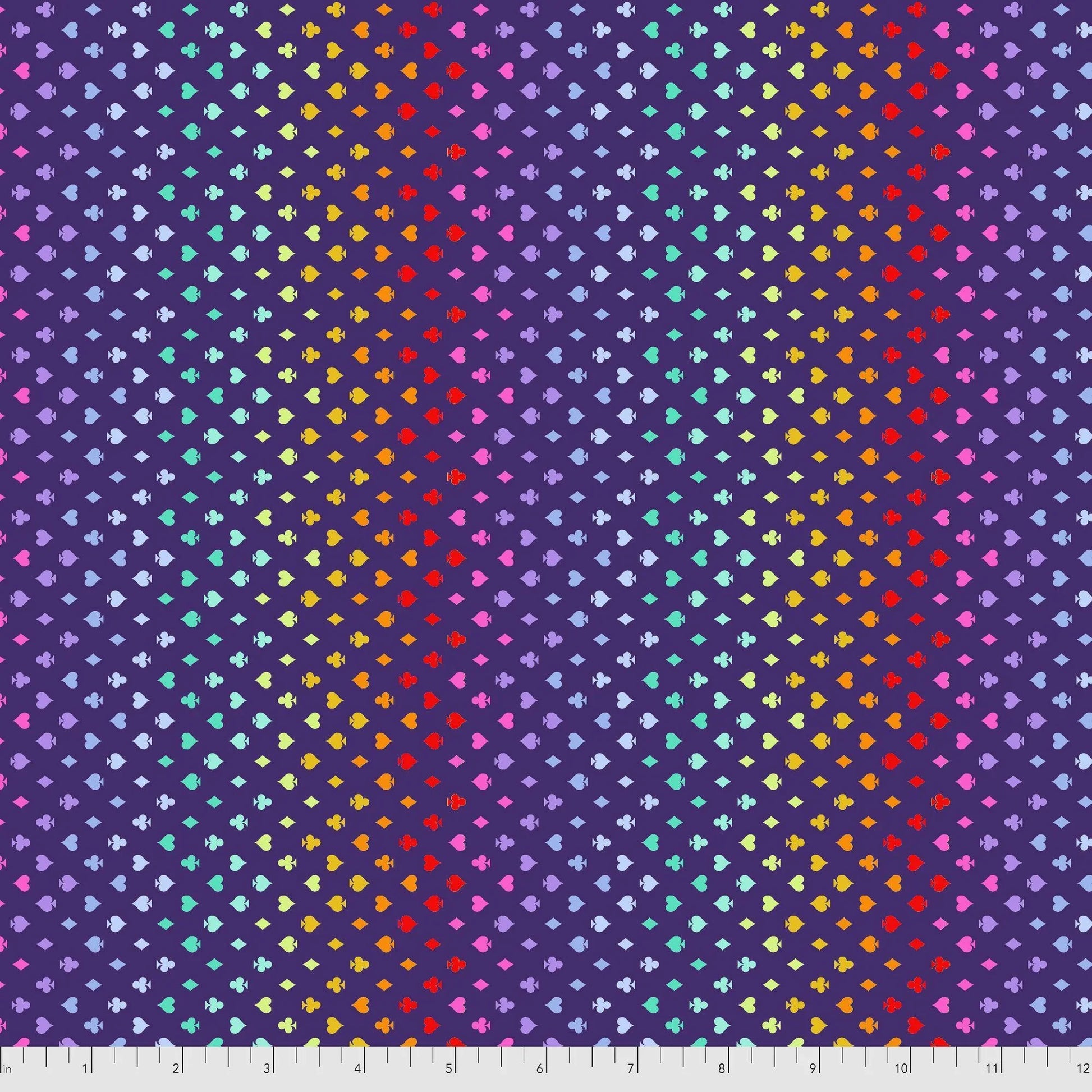 Colorful pattern of small card suite symbols on an indigo-purple background with a ruler for scale.
