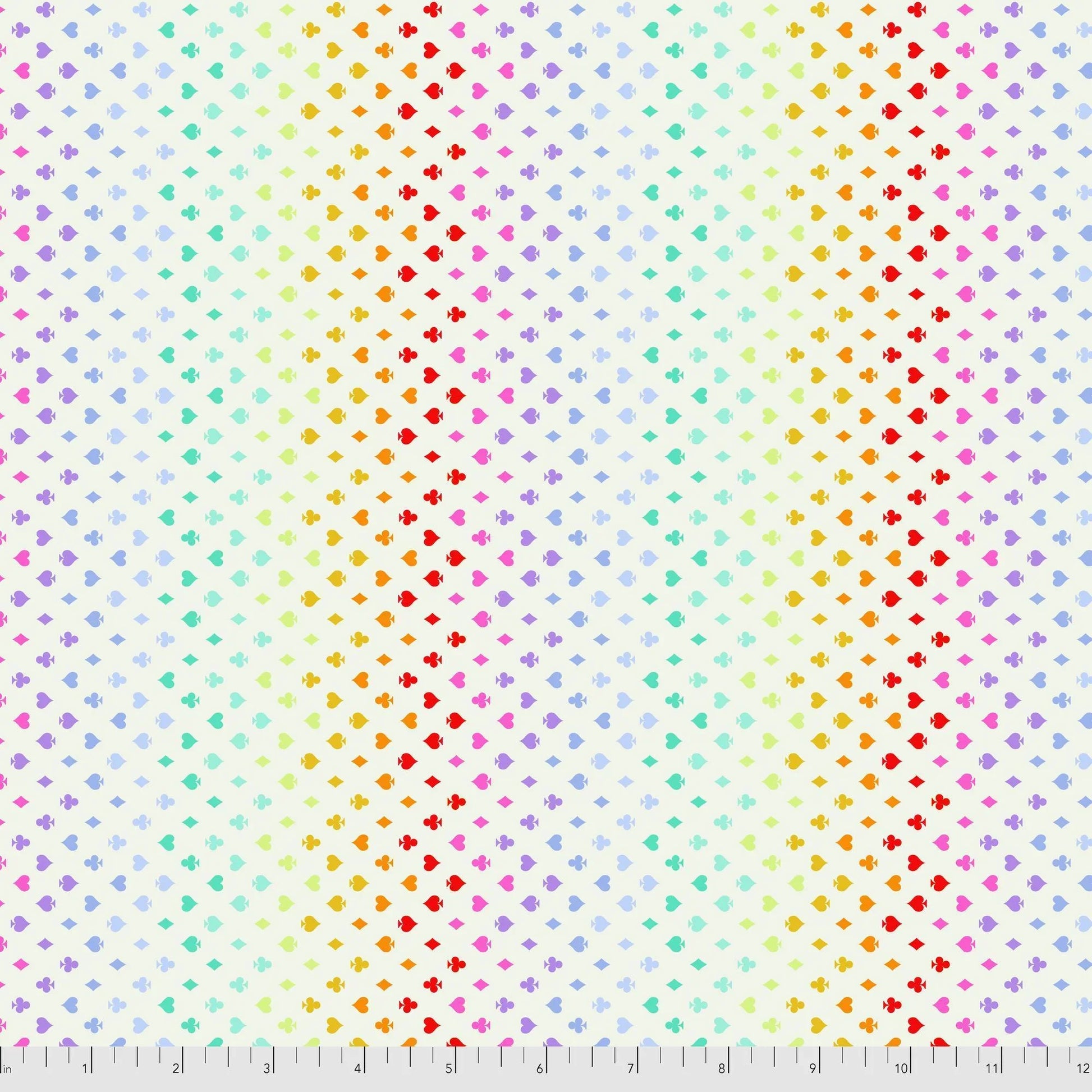 Colorful pattern of small card suite symbols on a cream background with a ruler for scale