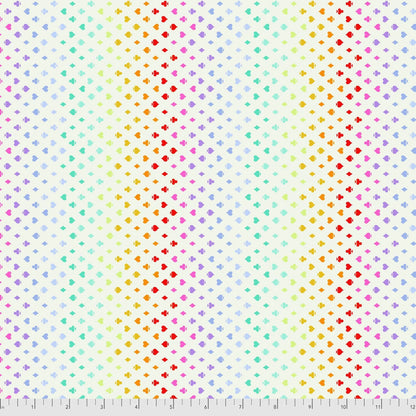 Colorful pattern of small card suite symbols on a cream background with a ruler for scale