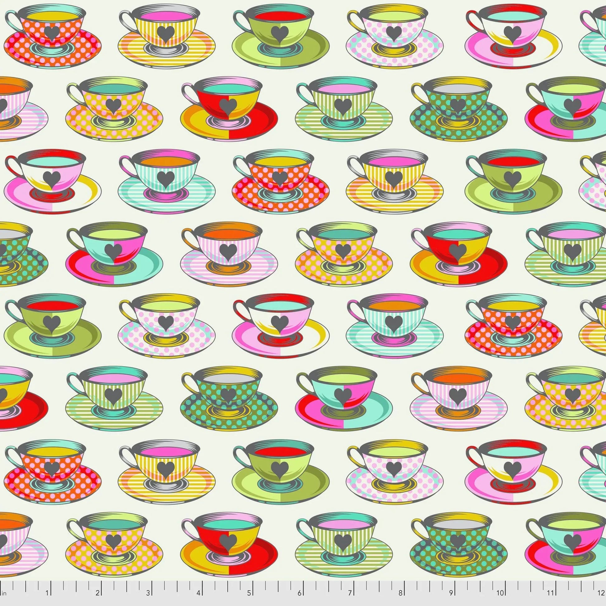 Pattern of colorful teacups and saucers on an off-white background with a ruler for scale