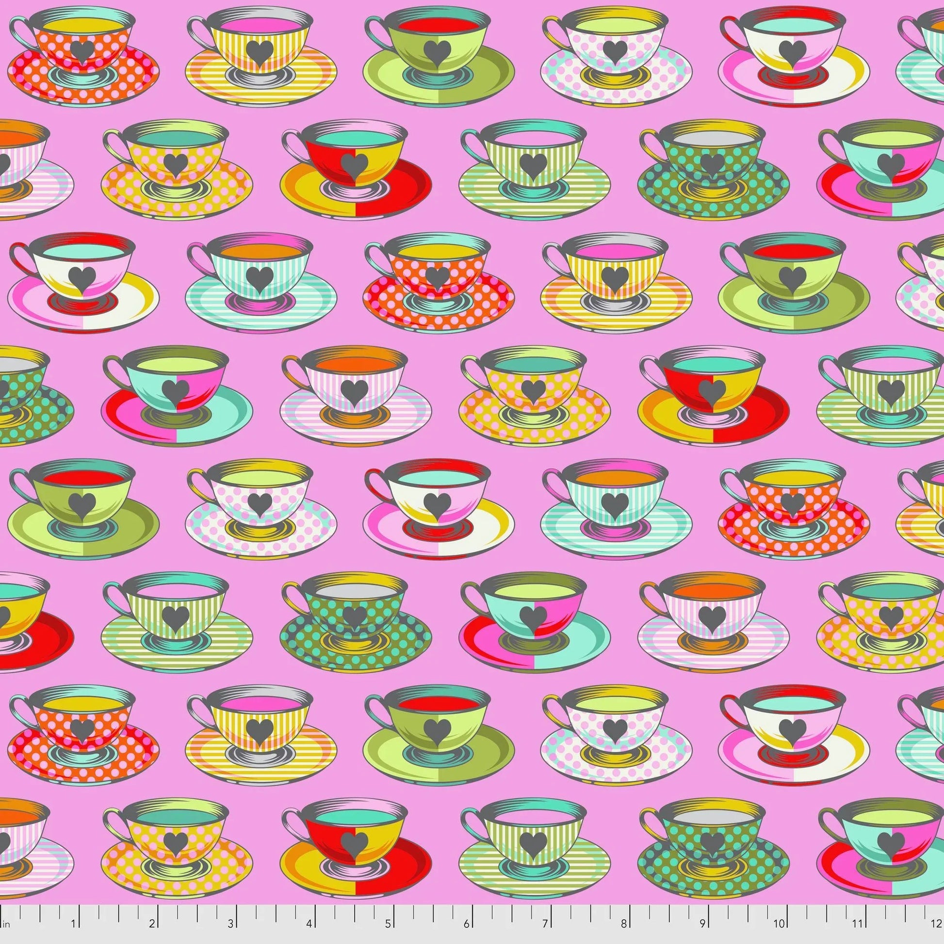 Pattern of colorful teacups and saucers on a pink background with a ruler for scale.