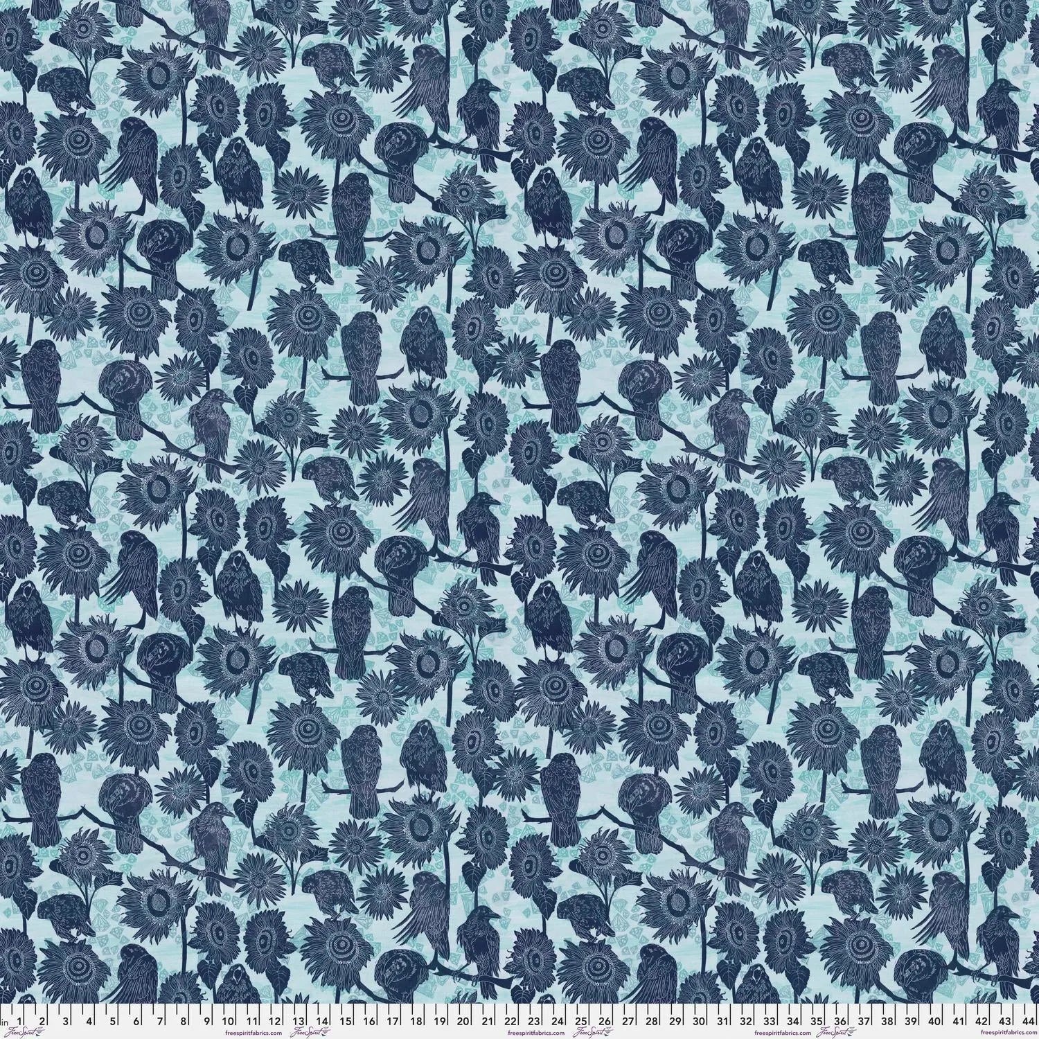 Pattern of navy blue birds and sunflowers on a powder blue background with a ruler for scale.
