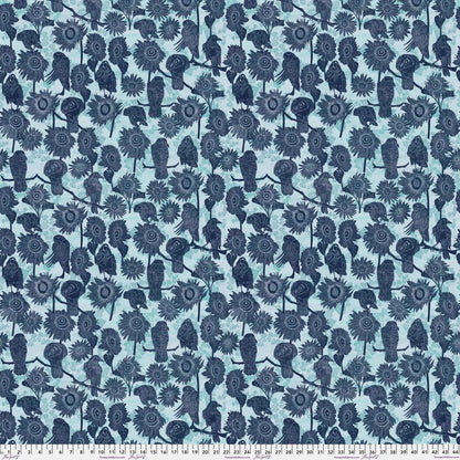 Pattern of navy blue birds and sunflowers on a powder blue background with a ruler for scale.