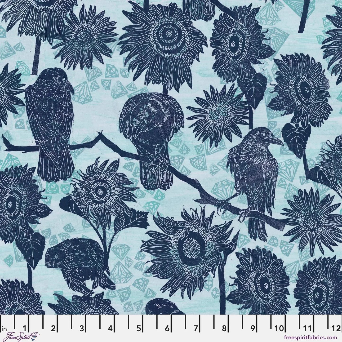 Pattern of navy blue birds and sunflowers on a powder blue background with a ruler for scale.
